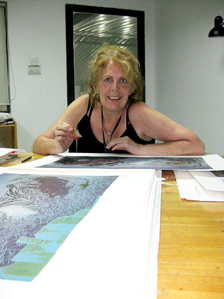 Frances stamping her seal on the prints